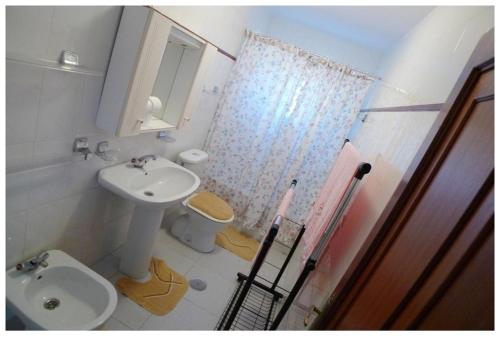 a bathroom with a sink and a toilet and a shower at Casa Carmiña in Villanueva de Arosa