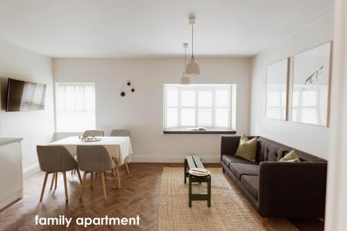a living room with a couch and a table at HIDEOUT Hotel in Hull