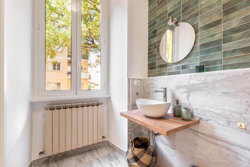 a bathroom with a sink and a window at Charming Apartment in the centre of Rome in Rome
