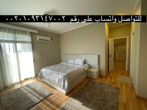 a bedroom with a bed in a room withjadavascript at Villa paradise for rent in Elshikh zayed in Abū Rawwāsh