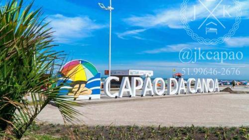 a sign for a car parked at the beach at Jk Beira Mar região central de Capão in Capão da Canoa