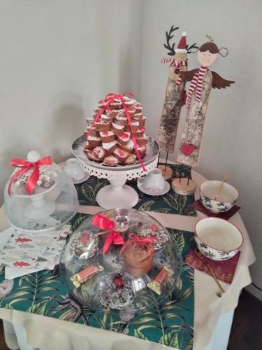 a table with a plate of food and a cake at Le Camere di Mara in Foligno