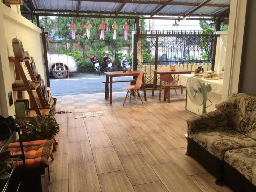 a living room with a couch and a table at Wayside Guesthouse in Chiang Mai