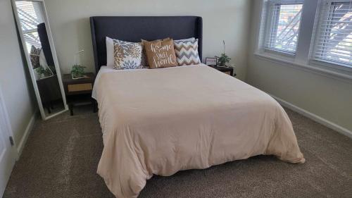 a bedroom with a large bed with pillows on it at Amazing 1 BR Apt In City Center in Detroit