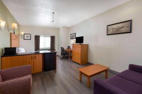 a living room with a couch and a desk in a room at La Quinta by Wyndham Tulare in Tulare