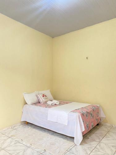 a bedroom with a bed in a room at Aconchego da Vó in Barreirinhas