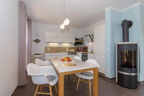 a kitchen with a table and chairs and a stove at Haus Emilia Whg Baltic Dreams in Rerik