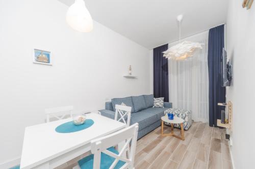 a living room with a couch and a table at La barca apartments in Becici