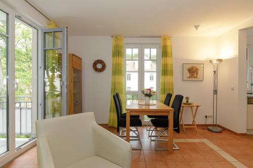 a living room with a table and chairs at Villa Antonia Whg_ 7 in Rerik