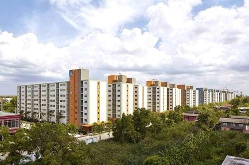 a group of tall buildings in a city at Baan Kidtang in Ban Talat Rangsit