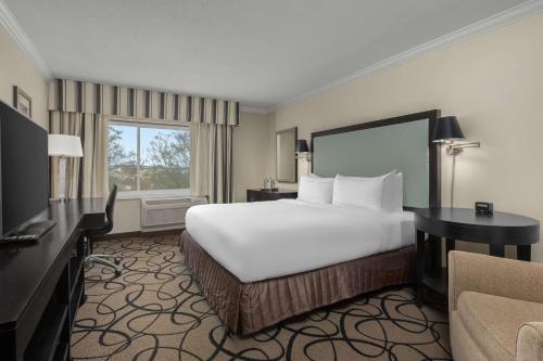 a hotel room with a large bed and a television at The Verve Boston Natick, Tapestry Collection by Hilton in Natick