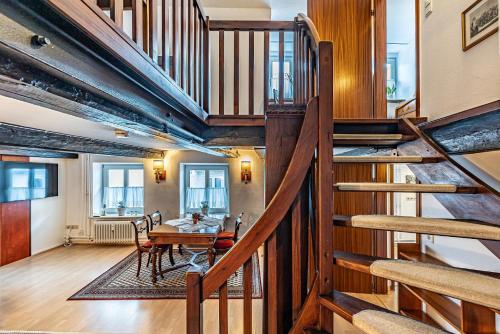 a room with a table and a wooden staircase at fewo1846 - Lille Petuhtante II - elegante Vintage-Wohnung mit 2 Schlafzimmern in Flensburg