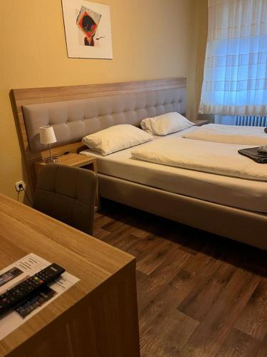 a bedroom with a large bed and a desk with a desk at Hotel zur Post limburg Bad camberg in Hünfelden