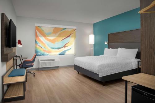 a bedroom with a bed and a desk and a chair at Tru By Hilton North Richland Hills Dfw West in North Richland Hills