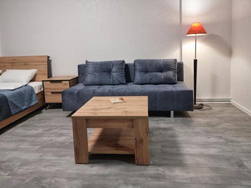 a living room with a couch and a coffee table at Home Hotel Apartments on Livoberezhna in Kyiv