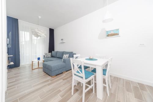 a living room with a table and a couch at La barca apartments in Becici