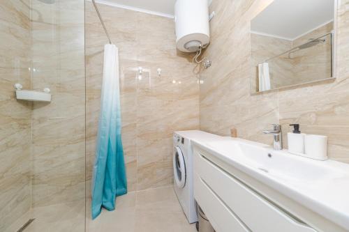 a bathroom with a sink and a glass shower at La barca apartments in Becici
