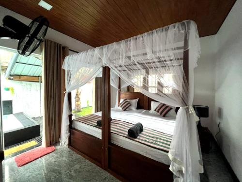 Postel nebo postele na pokoji v ubytování Mango Tree House Mirissa