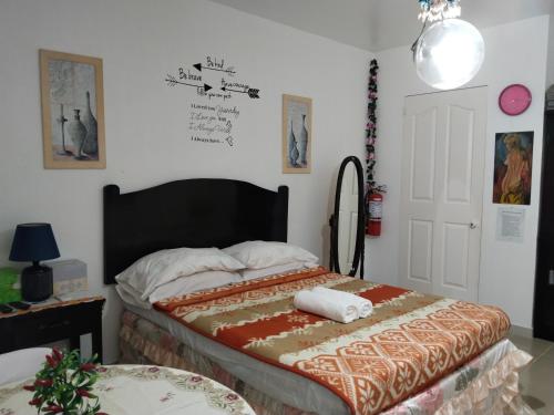 a bedroom with a bed with a blanket on it at M-J Room Rental in Alcoy