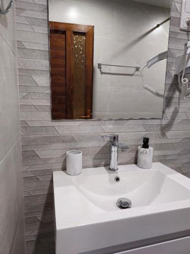 a bathroom with a white sink and a mirror at Park Resort Aghveran in Aghveran