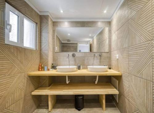 a bathroom with two sinks and a mirror at Charming 1 bedroom apartment near the center in Athens