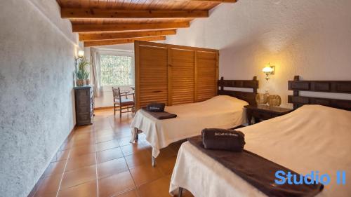 a hotel room with two beds and a table at Costacabana - Villa Pilar in Lloret de Mar