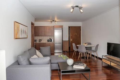 Charming apartment near center في أثينا: غرفة معيشة مع أريكة وطاولة
