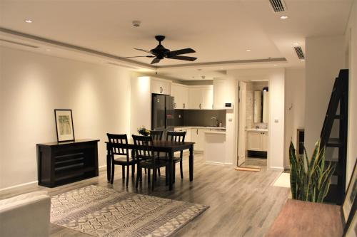 a kitchen and dining room with a ceiling fan at D’Leroi Soleil - Westlake Suite & Apartment in Hanoi