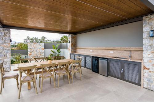 a dining room with a table and chairs at Imperium Luxury Villas-Sauna, Jacuzzi, Heated Pool & Gym-Chania in Kato Galatas