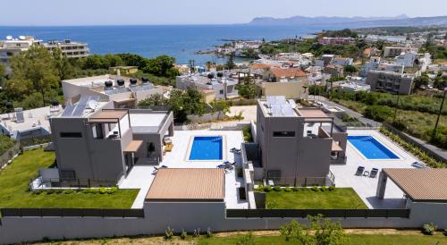 an aerial view of a house with a swimming pool at Imperium Luxury Villas-Sauna, Jacuzzi, Heated Pool & Gym-Chania in Kato Galatas