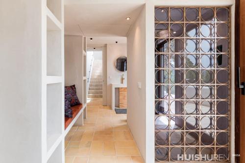 a hallway with a wall of wine glasses at Casablanca in Ses Salines