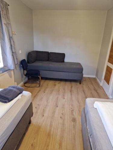 a room with a couch and a chair in it at Lækjarhus Farm Holidays in Borgarhöfn