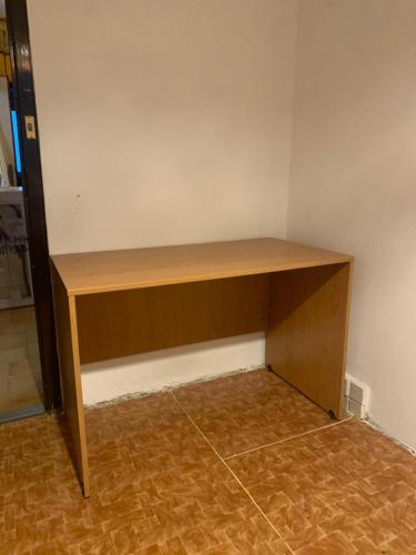 a wooden desk in a corner of a room at Lovely room for 2 persons in 3 room flat in Košice