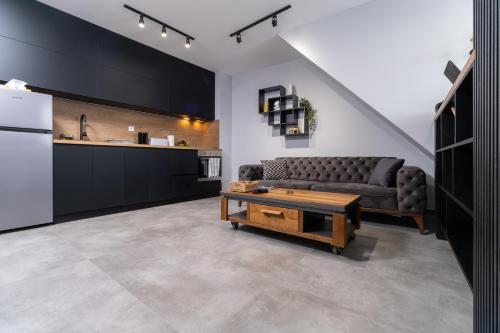 a living room with a couch and a coffee table at Chic 1BR Apartment with Balcony in Plovdiv in Plovdiv