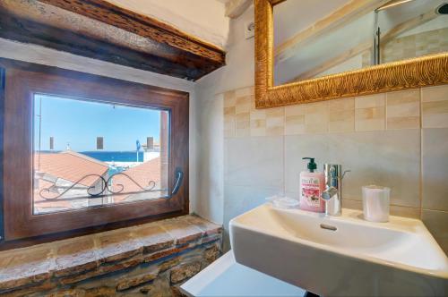 a bathroom with a sink and a window at Apartment Etta in Fažana