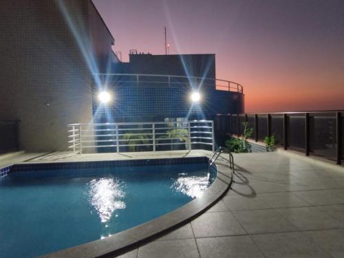 a swimming pool on the roof of a building at night at Ocean Atlantic Praia de Iracema in Fortaleza