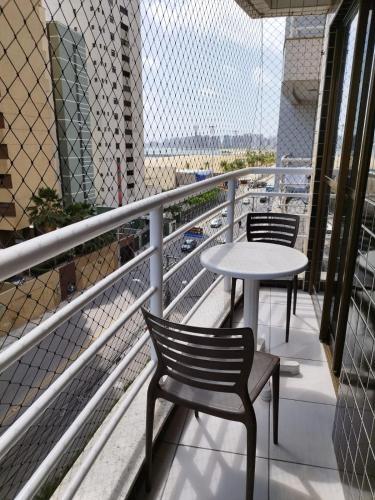 a balcony with two chairs and a table on a building at Ocean Atlantic Praia de Iracema in Fortaleza