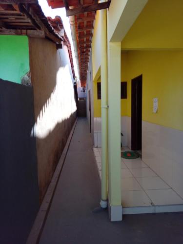 an empty hallway of a building with yellow walls at Aconchego da Vó in Barreirinhas
