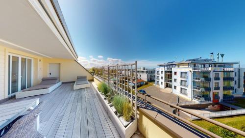 an apartment balcony with a view of a city at Villa Strandvogt in Börgerende-Rethwisch