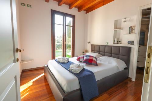 ペスキエーラ・デル・ガルダにあるLugana Resort & Sporting Club - Sermana Villageの窓付きの部屋にベッド付きのベッドルーム1室があります。
