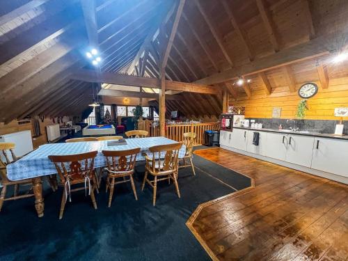 a kitchen and dining room with a table and chairs at Stunning Log Cabin With A Pool Table For Hire In Norfolk, Sleeps 8 Ref 34045al in King's Lynn