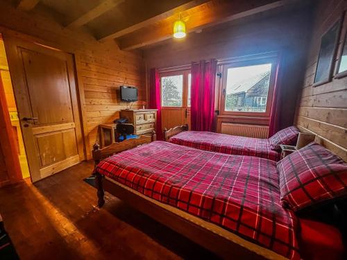 a bedroom with two beds and a window at Stunning Log Cabin With A Pool Table For Hire In Norfolk, Sleeps 8 Ref 34045al in King's Lynn