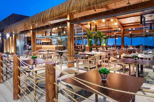 a restaurant with wooden tables and chairs at Melia Costa del Sol in Torremolinos