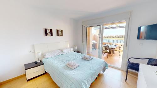 a white bedroom with a bed and a balcony at Casa Espliego V-A Murcia Holiday Rentals Property in Torre-Pacheco