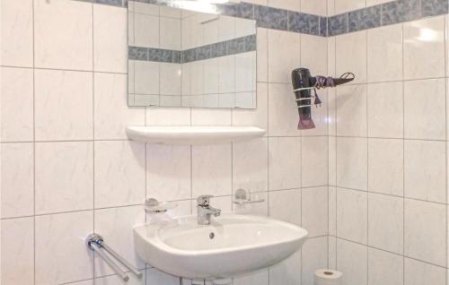 a white bathroom with a sink and a mirror at Amazing Apartment In Rauris With 1 Bedrooms in Rauris
