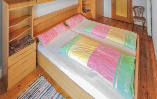 a bed with colorful sheets in a bedroom at Beautiful Home In Radstadt With 2 Bedrooms in Radstadt