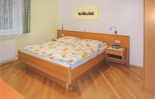 a bedroom with a bed with a wooden headboard at Beautiful Apartment In Wagrain With 2 Bedrooms And Wifi in Wagrain