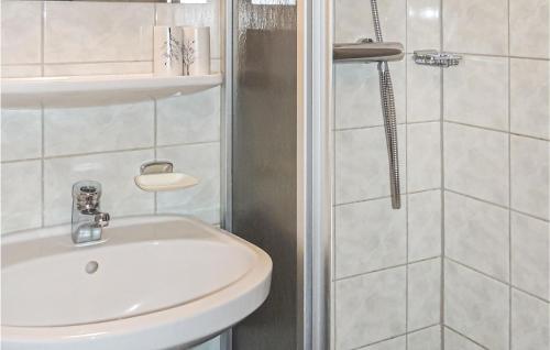 a white bathroom with a sink and a shower at Beautiful Apartment In Wagrain With 2 Bedrooms And Wifi in Wagrain