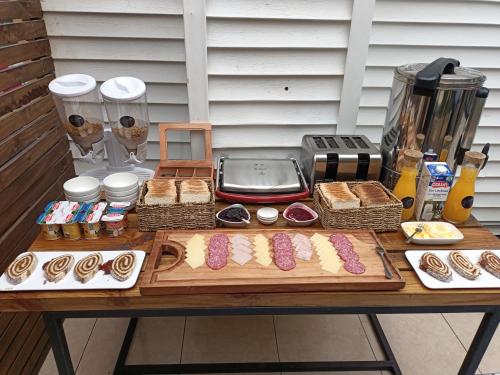 a table with pastries and other food on it at La Magia del Sur Valdivia in Valdivia