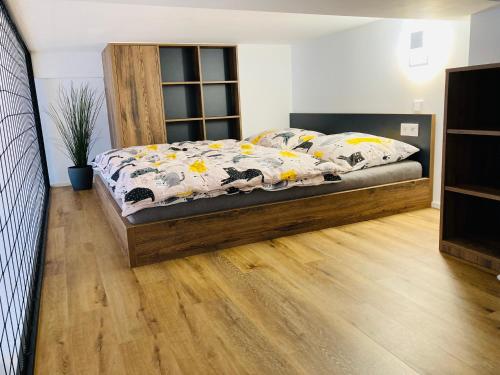 a bedroom with a bed with a comforter on it at Residence Lysá Hora in Rokytnice nad Jizerou